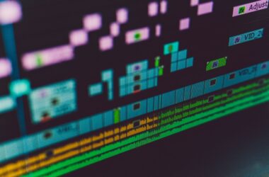raking macro of a multi-track NLE timeline on a dark monitor
