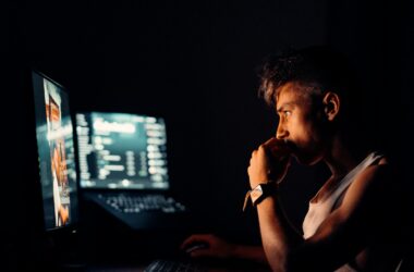 woman in black tank top sitting in front of computer