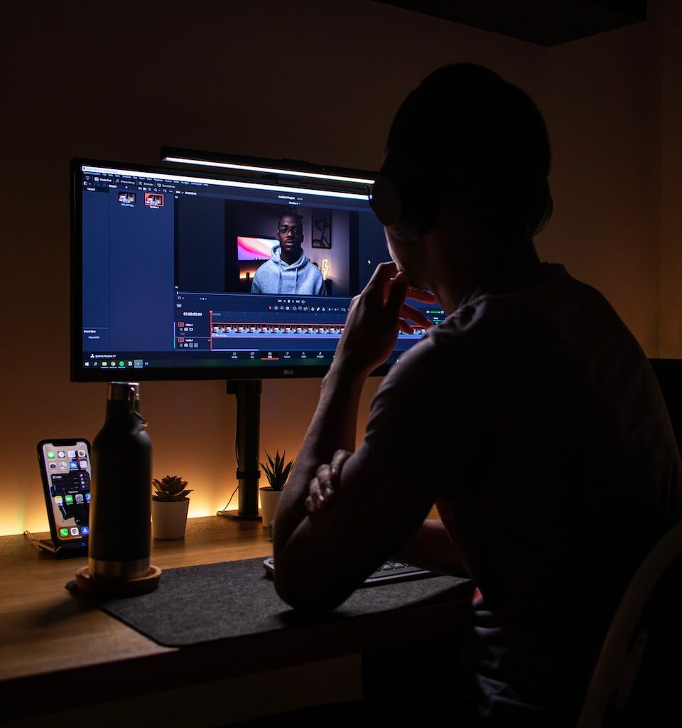 boy in black long sleeve shirt sitting on chair in front of black flat screen tv