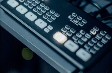 Blackmagic ATEM Mini switcher on desk, program button lit red