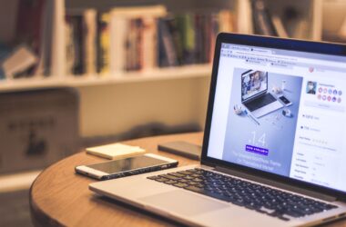 WordPress theme listing on a laptop, warm-lit desk, bookshelf