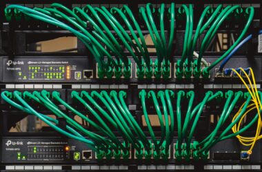 Rack-mounted network switches with green patch cables