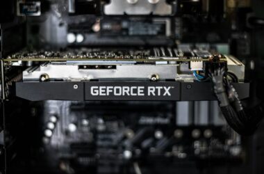 GeForce RTX card seated in a dark workstation, motherboard behind