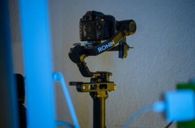 DJI Ronin gimbal with camera on stand, blue-lit dim room
