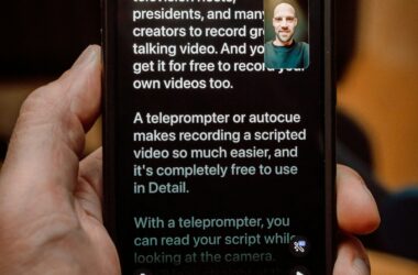 Hand holding phone running teleprompter app, scrolling script, record button