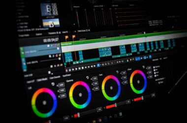 A color grading panel with four color wheels on a dark monitor