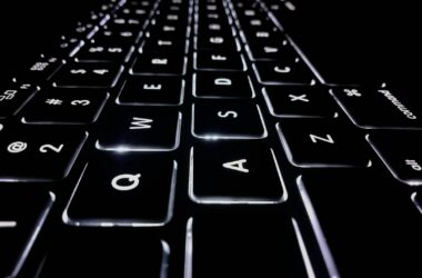 Closeup of a backlit black keyboard with white key legends