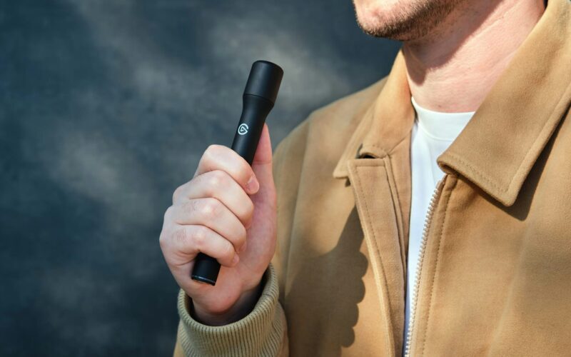 A person holding the Elgato Wave Go in handheld mode