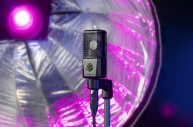 Lewitt large-diaphragm condenser microphone on a stand with an XLR cable, in front of a studio light
