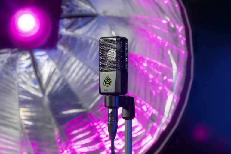 Lewitt large-diaphragm condenser microphone on a stand with an XLR cable, in front of a studio light